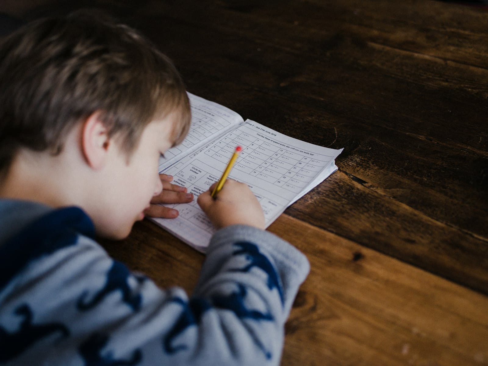 A boy writing in a notebook