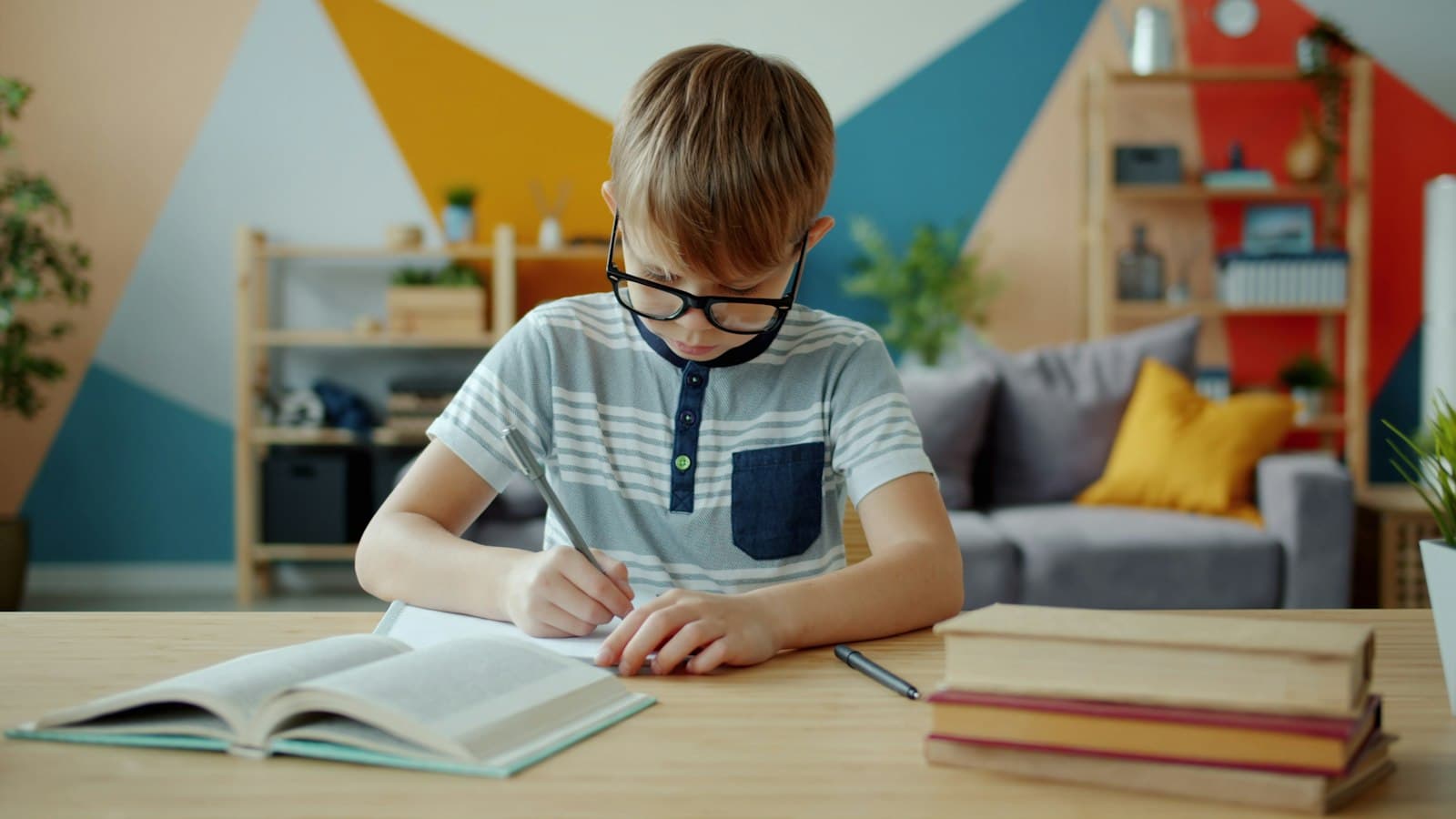 A school age boy doing homework at a desk