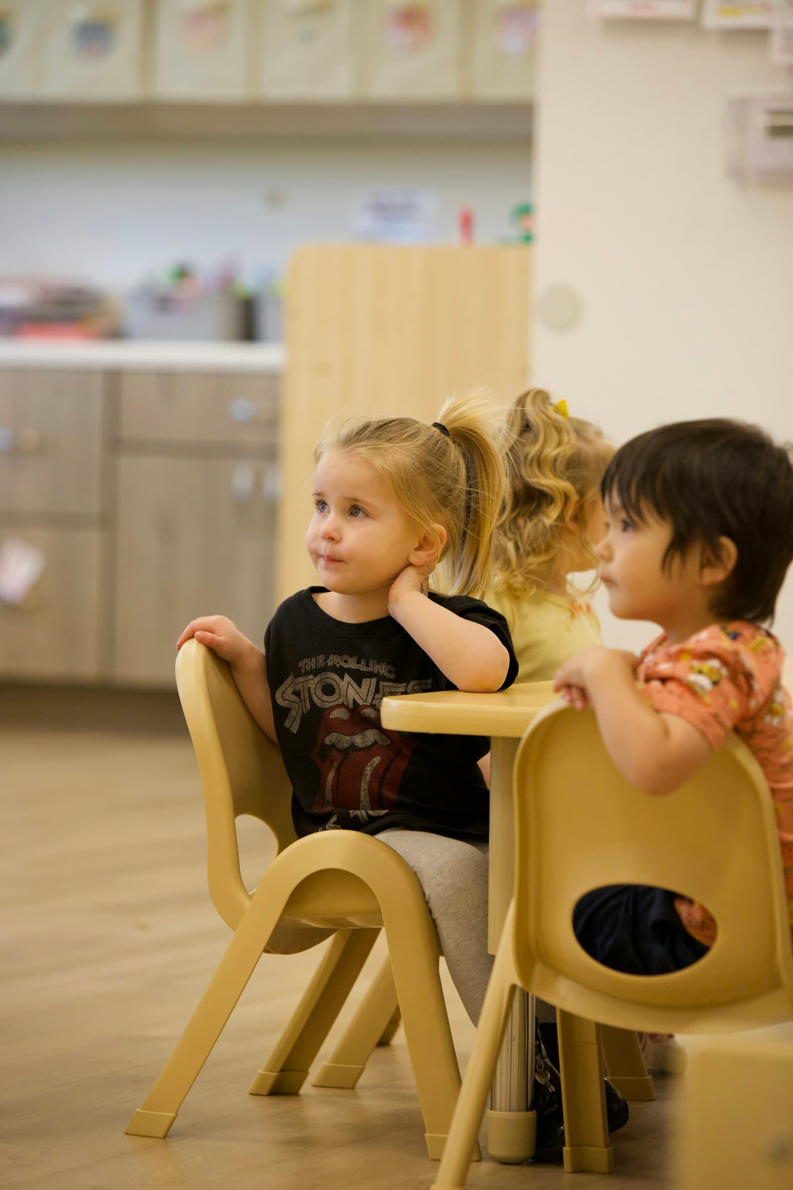 Young children seated together at a classroom table