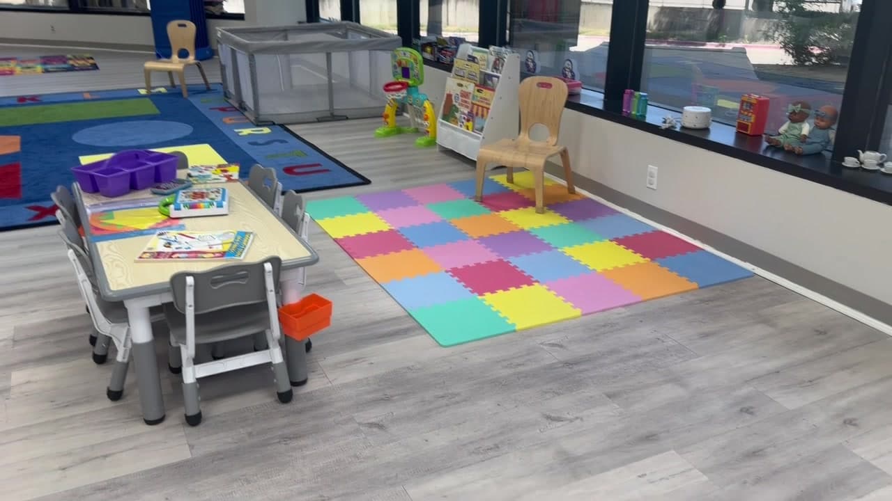 Colorful floor mats and a rug in a K+3 classroom